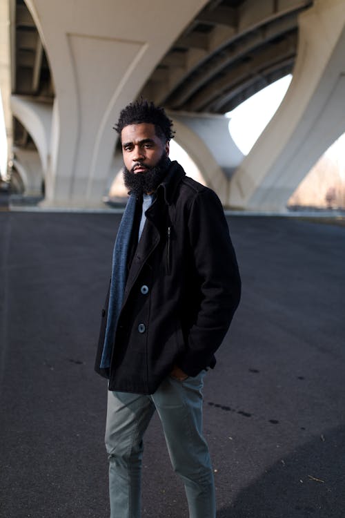 Man in Black Double-breasted Jacket in Shallow Photography