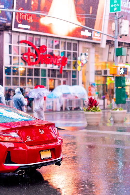 Red Honda Car on the Street on a Rainy Day