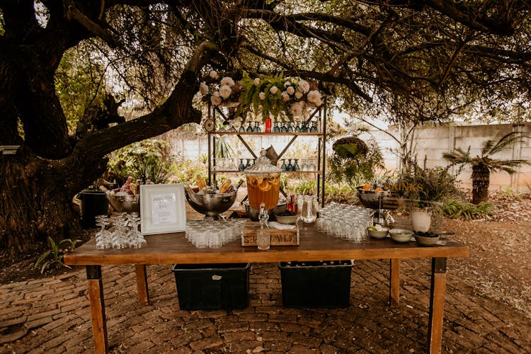 Table With Glasses And Drinks In Garden