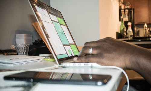 Person Using Laptop Computer Inside Room