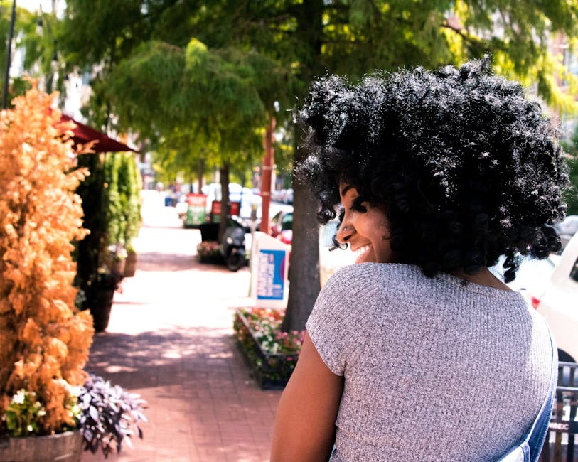 A woman smiling and walking comfortfully in a park, representing a quick return to normal life - gynecology and minimally invasive therapy A woman smiling and walking comfortfully in a park, representing a quick return to normal life - gynecology and minimally invasive therapy