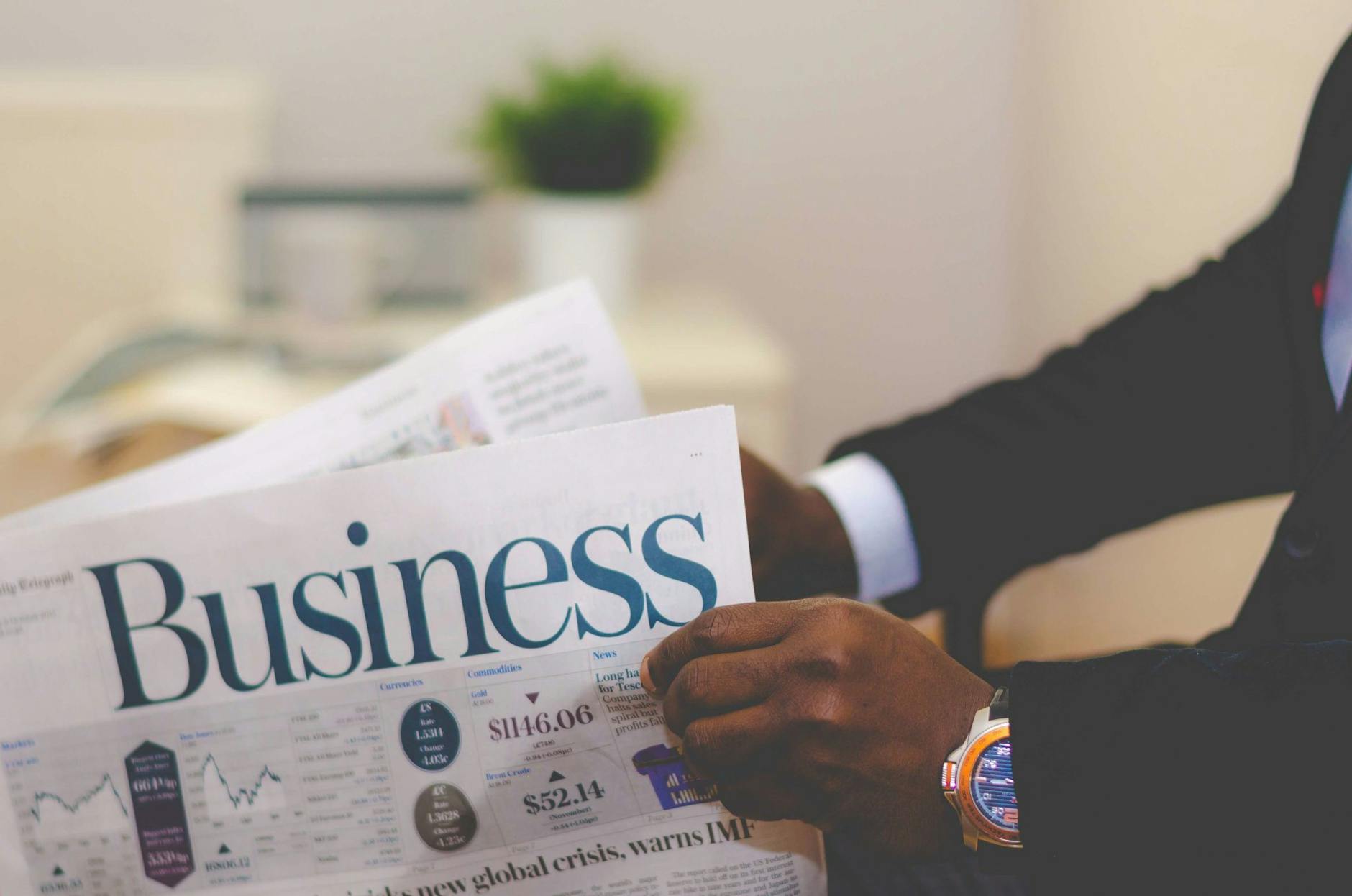 Person holding white and blue business paper