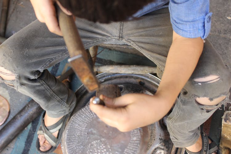 Closeup Of A Blacksmith Engraving With Metal Nail And Hammer