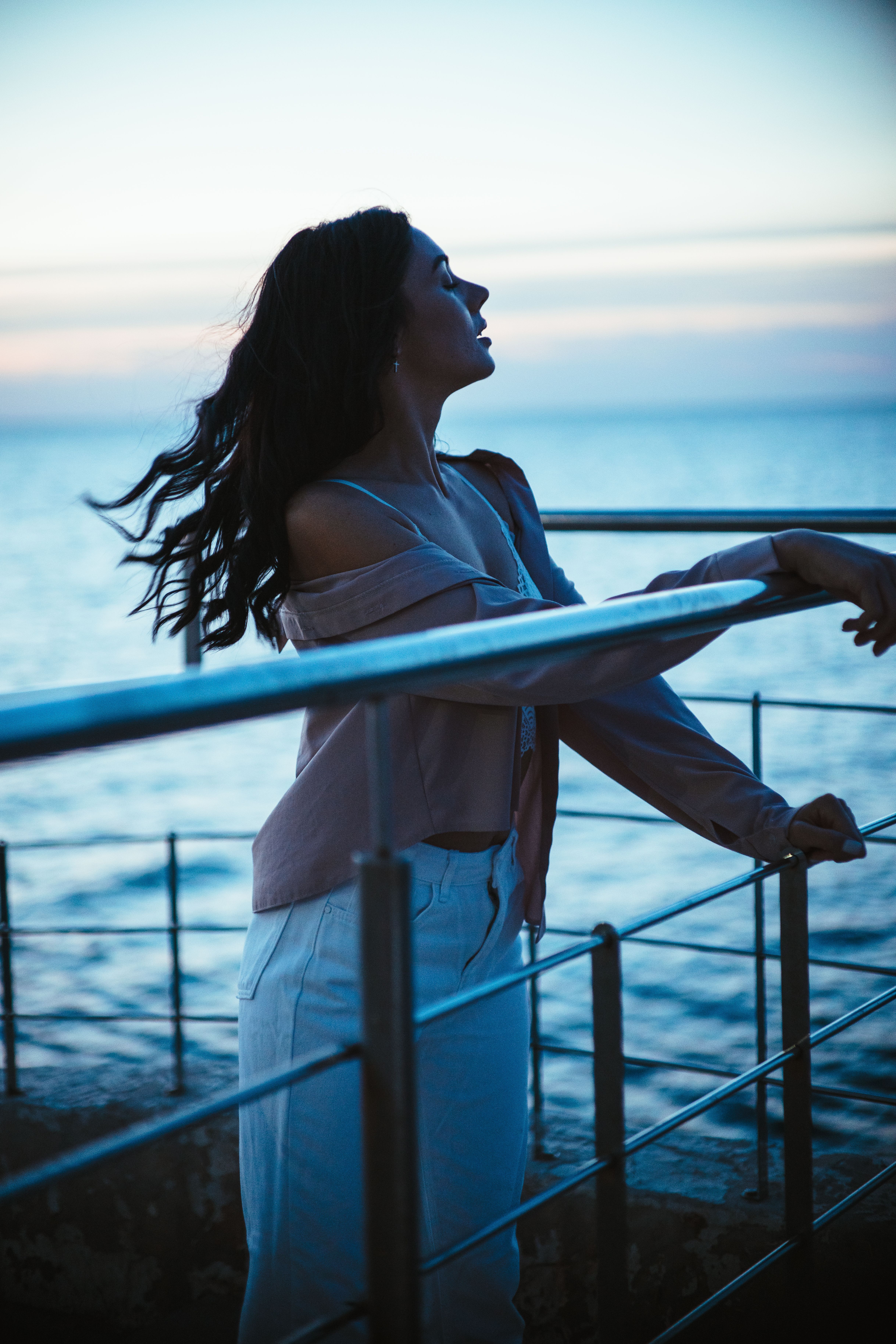 Woman Holding on Metal Railing · Free Stock Photo