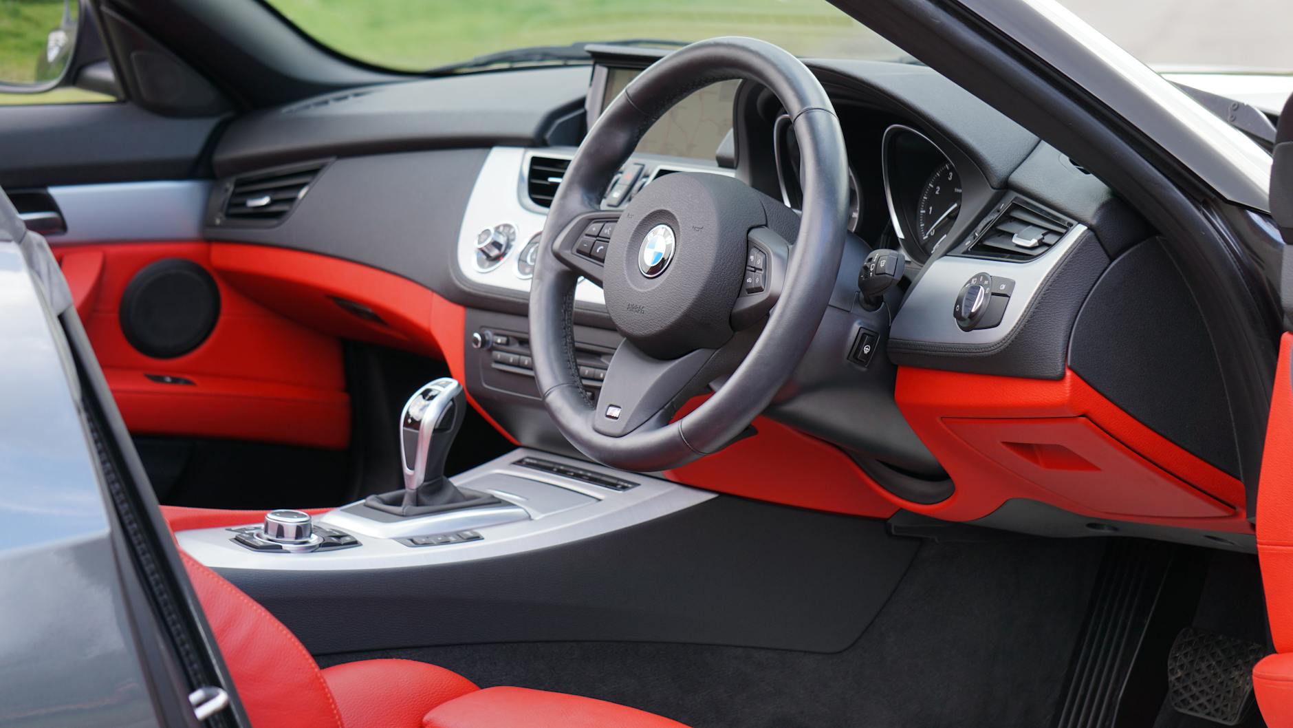 Explore the sleek and luxurious interior of a BMW Z4 featuring vibrant red accents and modern design.
