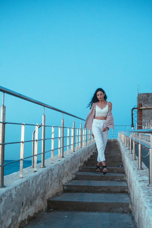 Sexy Woman Walking on Concrete Stairs