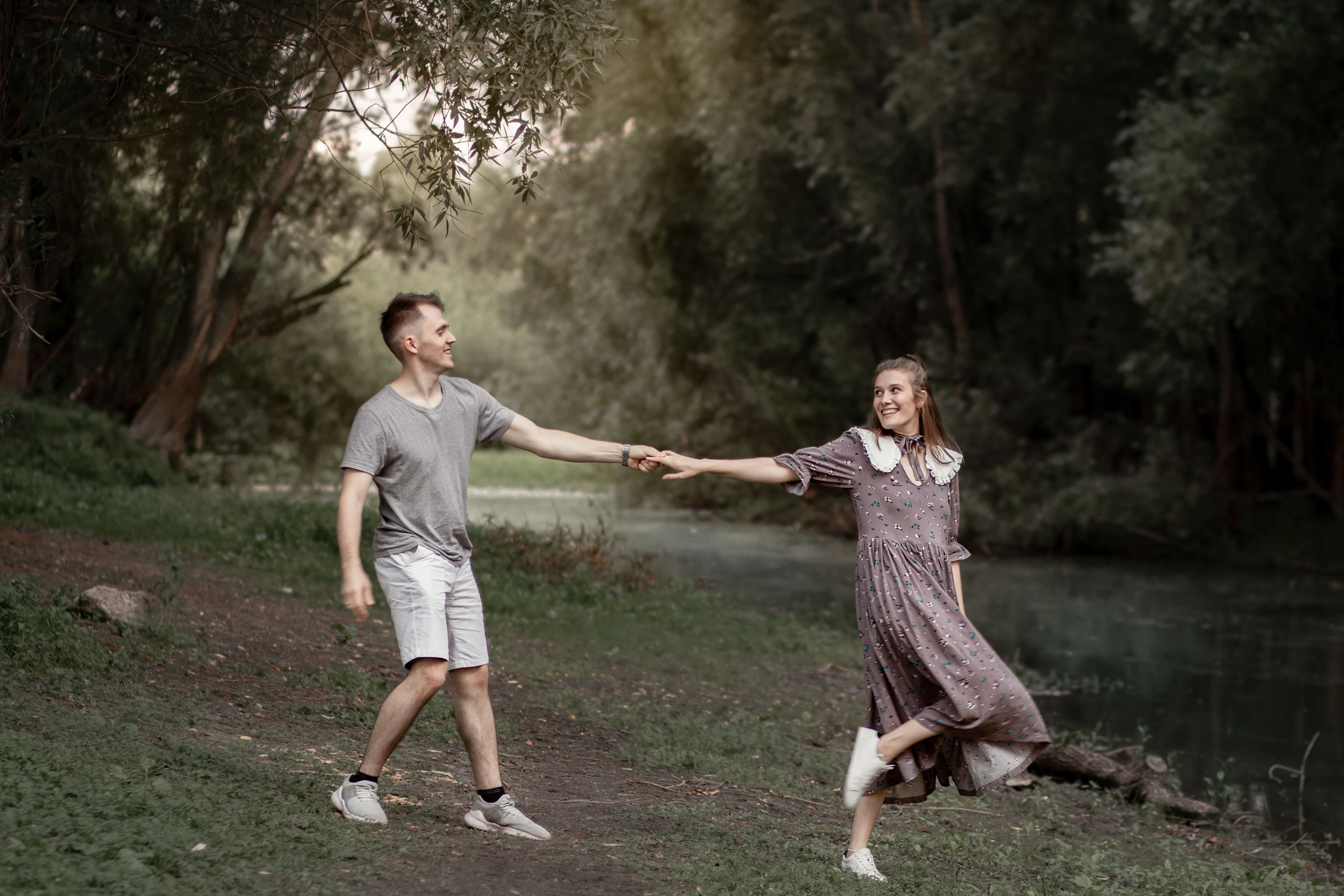 happy teen couple walking in a park together - solo parenting teen dating rules