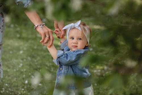 Free Shallow Focus of a Cute Baby with Her Parent Stock Photo