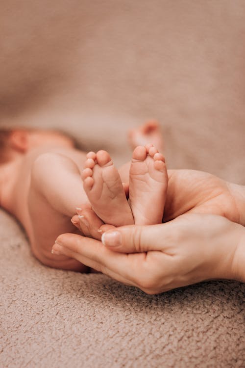 Free Person Holding Baby Feet Stock Photo