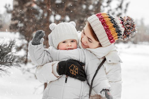 Free A Mother and Daughter Enjoying the Outdoor Snow Stock Photo