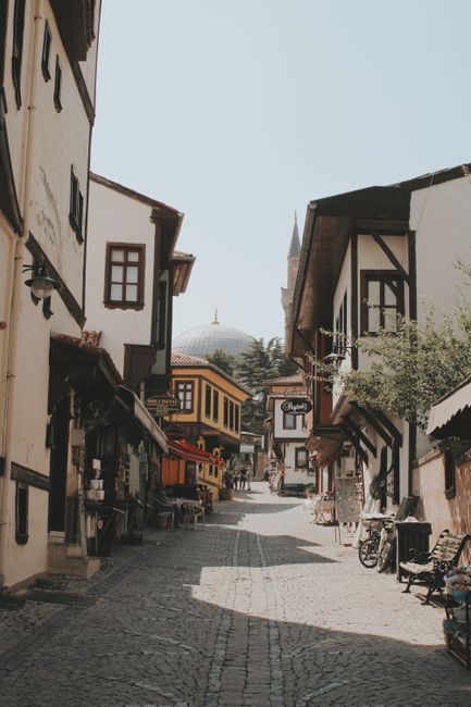 Explore a picturesque street in Eskişehir, Turkey, showcasing traditional architecture under a clear sky.