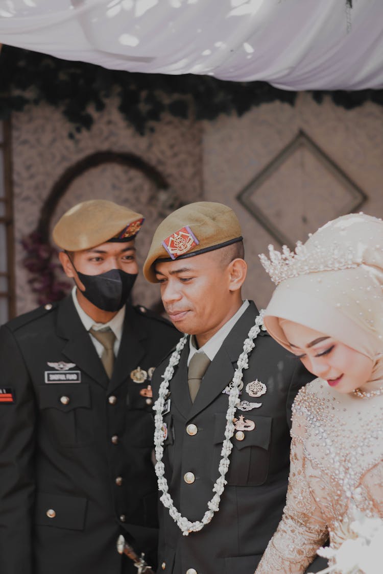 Military Man And Woman In White Dress At Their Wedding