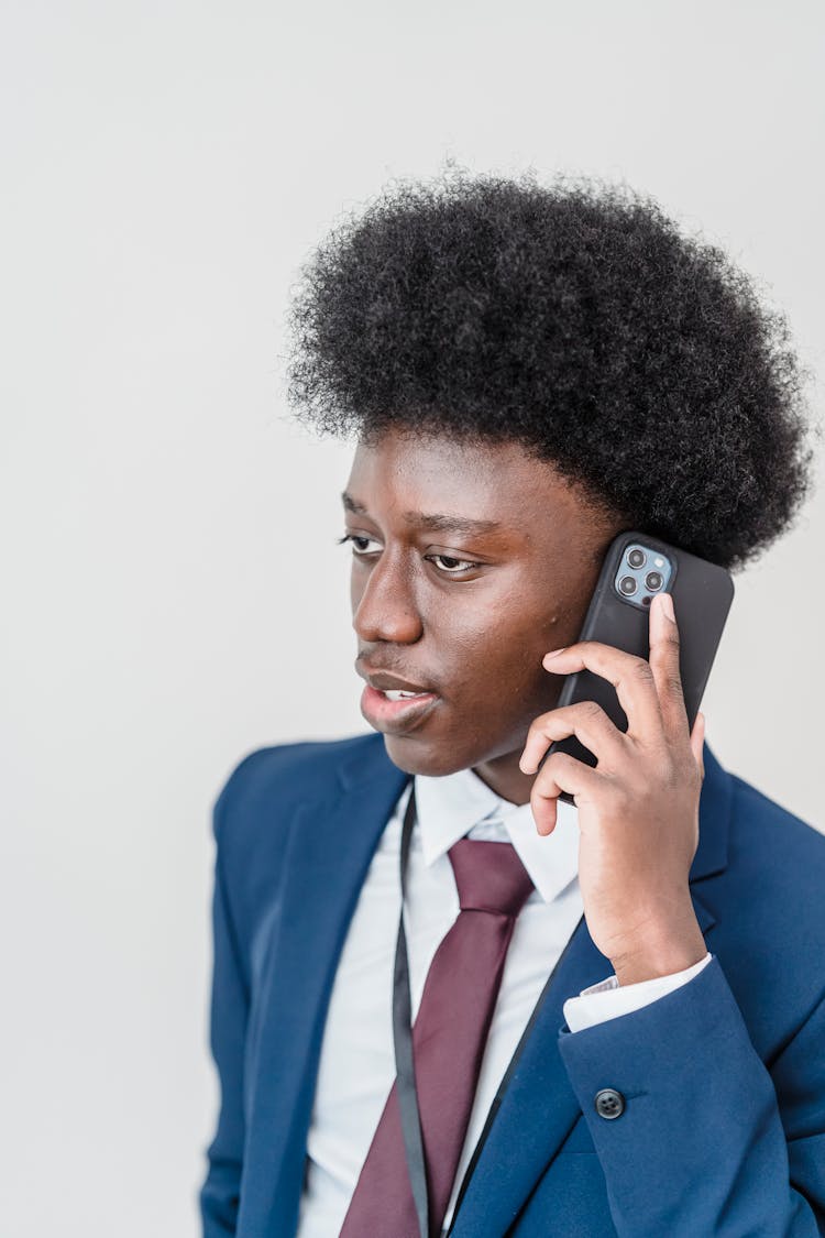 Man In Blue Suit Jacket Holding Phone