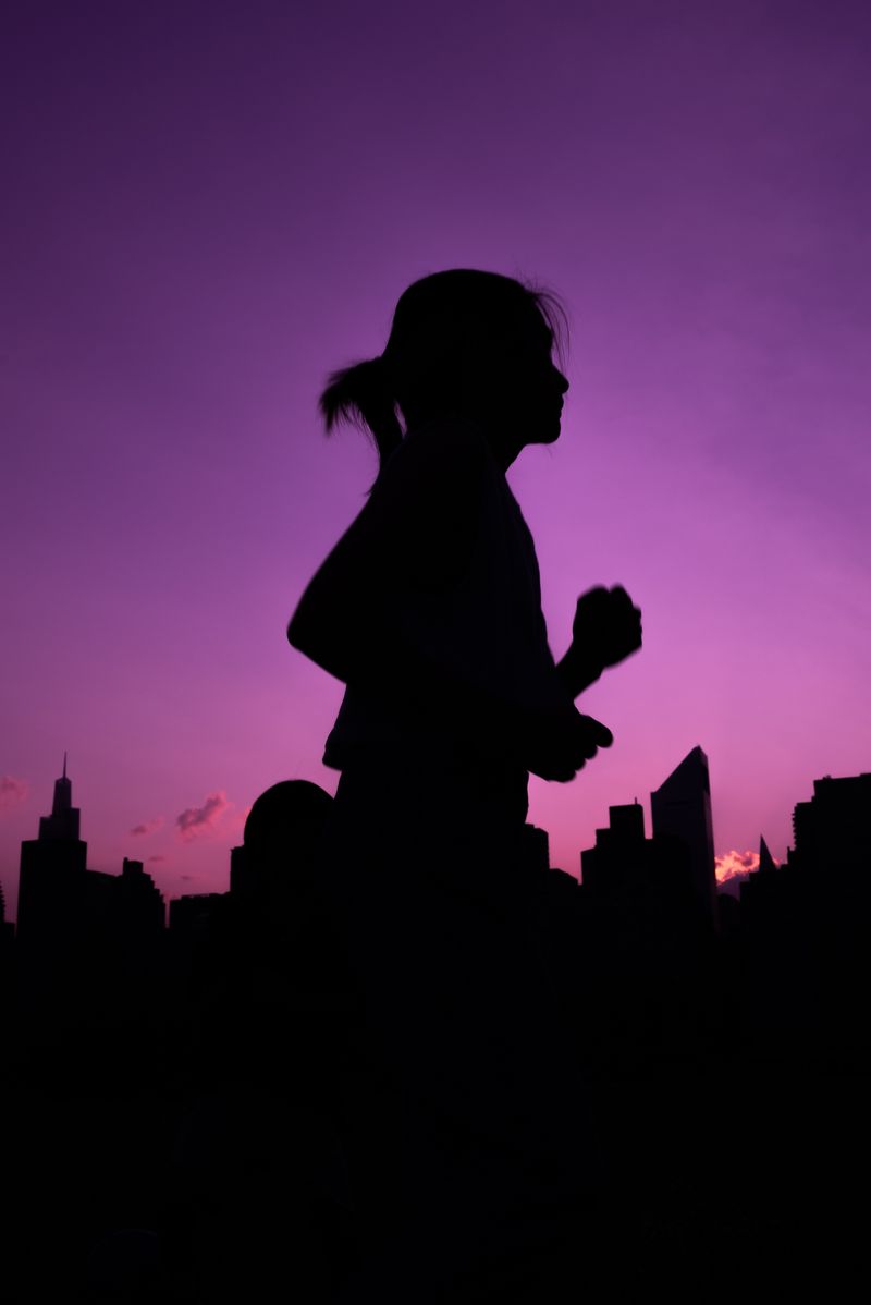 Silhouette of a woman running against a city skyline at dusk, photo by Lara Jameson on Pexels