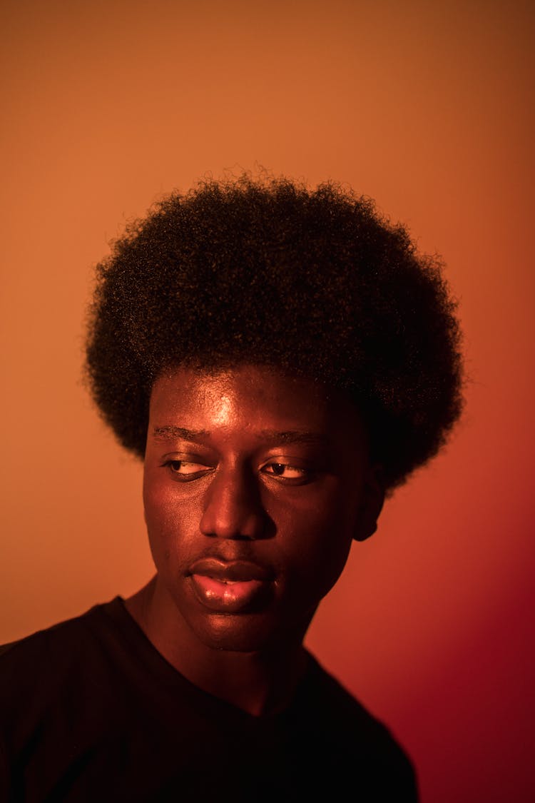 Young Man On Orange Studio Background