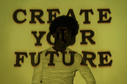 Free A creative portrait with 'Create Your Future' text projected on a person. Stock Photo