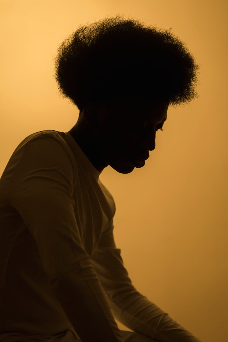 Silhouette Of A Man Wearing A Long Sleeve Shirt