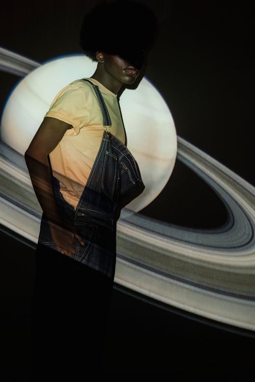A Man in Overalls with a Planet Background