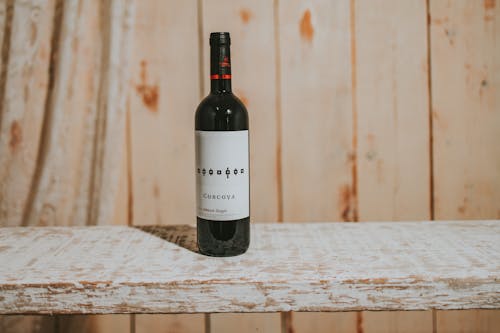 Close Up Photo of Corcova Wine Bottle on Wood Plank