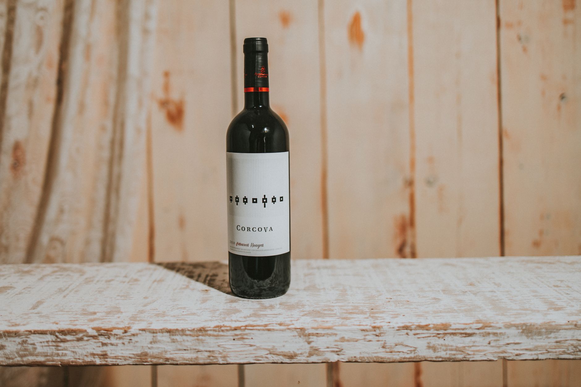 Close Up Photo of Corcova Wine Bottle on Wood Plank