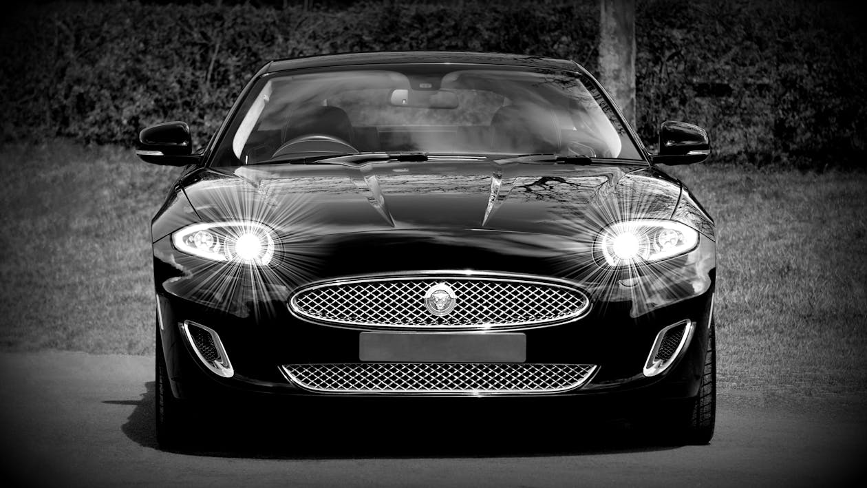 Grayscale Photo of a Black Sports Car Convertible
