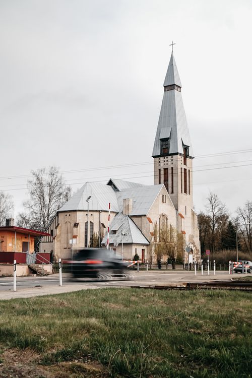 Free A captivating view of a Lutheran church facade with a gray sky in Riga, Latvia, capturing both history and modernity. Stock Photo
