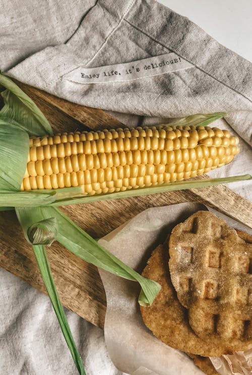 Free Corn on Gray Textile Beside Yellow Corn Stock Photo