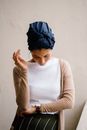 Woman Wearing Blue Turban, White Top and Brown Cardigan