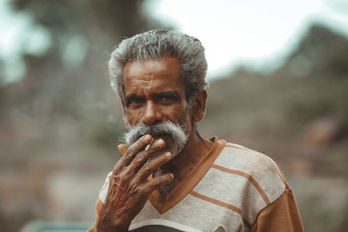 Man with Gray Hair Smoking a Cigarette