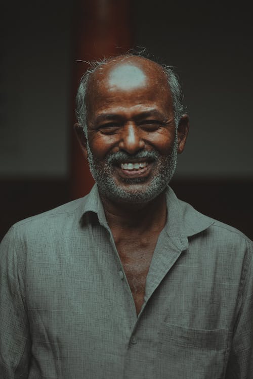 Smiling Elderly Man Wearing a Gray Shirt