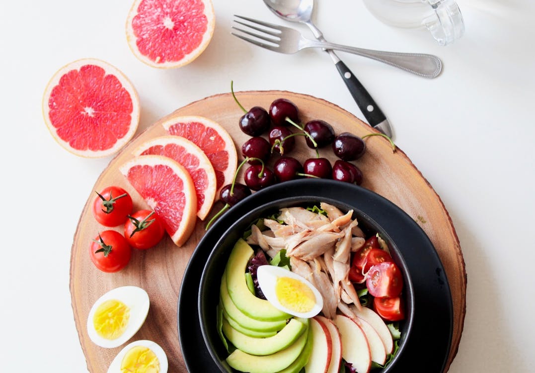 Bowl of Vegetable Salad and Fruits