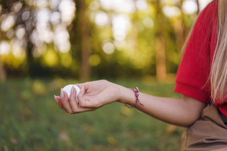 Person Holding A Golf Ball