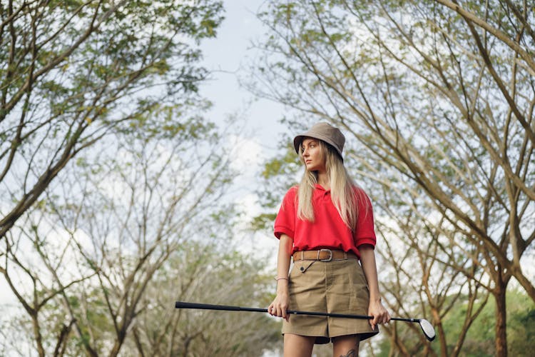 Low-Angle Shot Of A Woman In Red Polo Shirt Holding A Golf Club