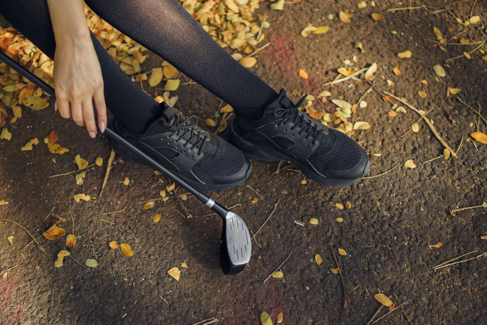 Woman wearing knee-high socks while walking outdoors on a bright day
