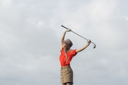 Free A Woman Holding a Golf Club Stock Photo
