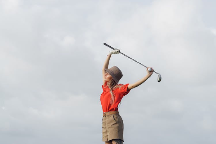 A Woman Holding A Golf Club