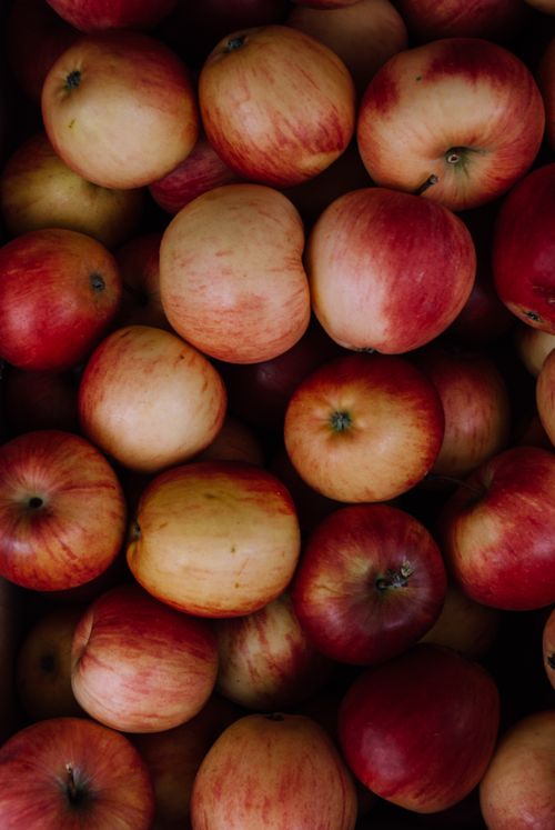Free A close-up view of freshly harvested red apples displaying their vibrant color and juicy texture. Stock Photo