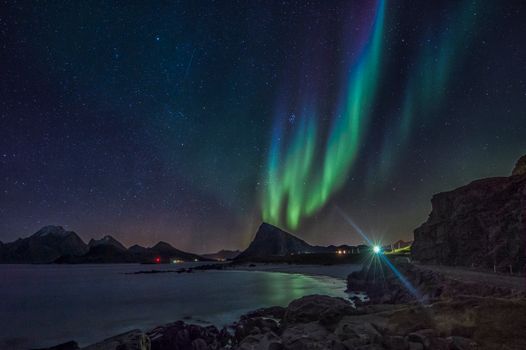 Magical view of the aurora borealis illuminating the night sky over the Lofoten Islands, Norway.