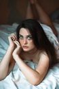 Woman in White Dress Lying on Bed