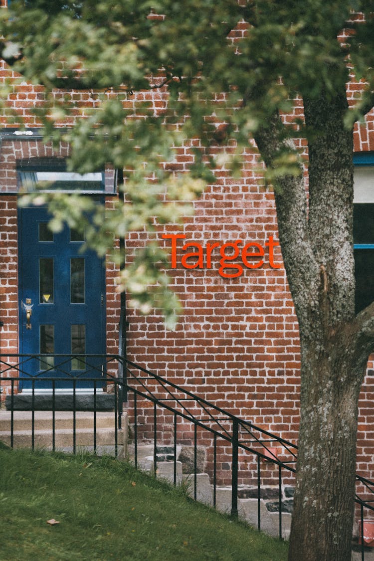 Tree Growing Near Shop Brick Facade