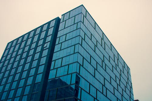 Free Low Angle Photography of Glass Building Stock Photo