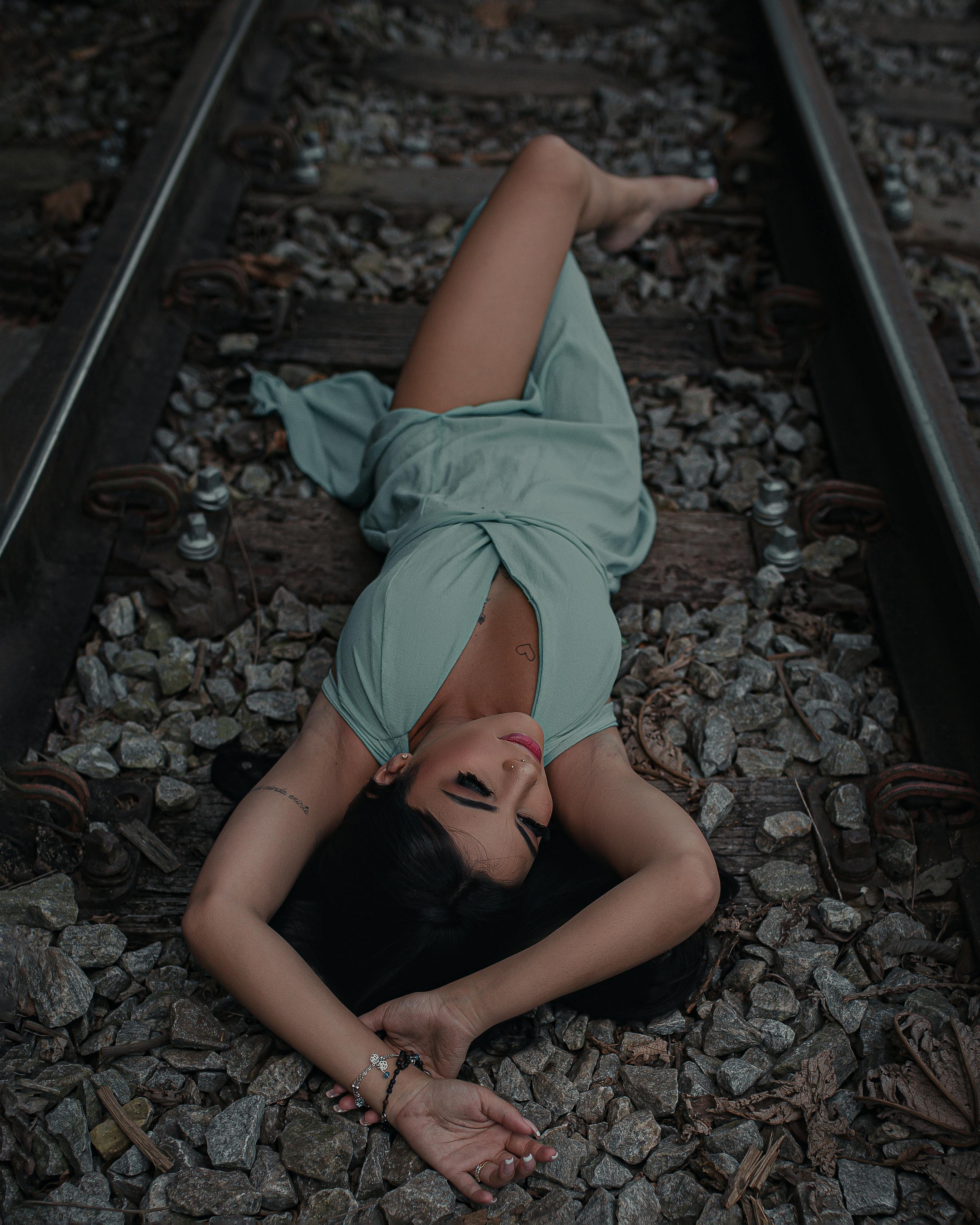 Woman posing on railway tracks in Mariana, Brazil. Outdoor fashion portrait.