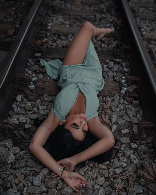 Woman posing on railway tracks in Mariana, Brazil. Outdoor fashion portrait.