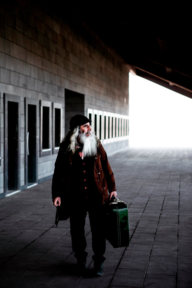 Old Bearded Man With Suitcase Walking Outdoors