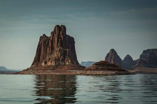 Brown Rock Formations Beside Body of Water