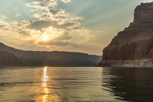 Brown Rock Formations Beside Body of Water