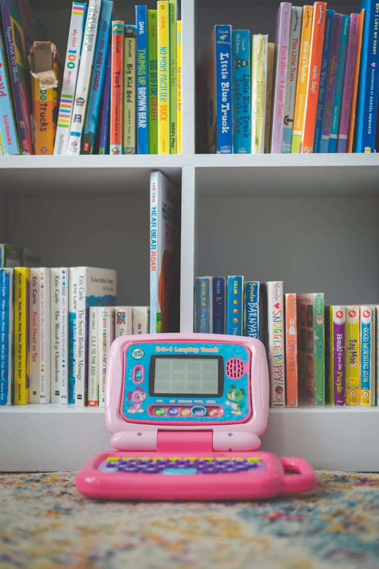 Children Toy Computer Near Bookshelf