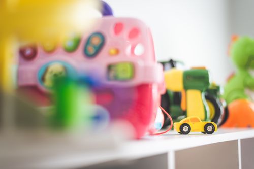 Free Vibrant collection of children's toys featuring a miniature yellow car in focus. Stock Photo