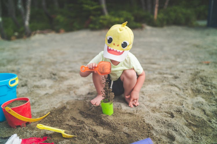 A Child Shoveling Sand