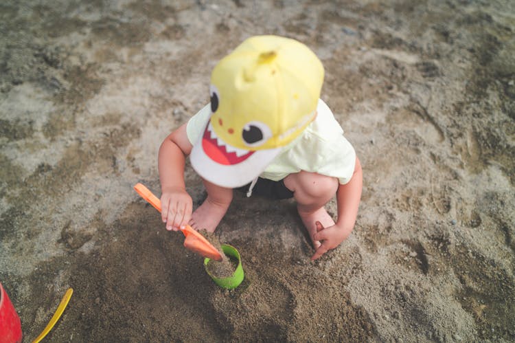 A Child Shoveling Sand